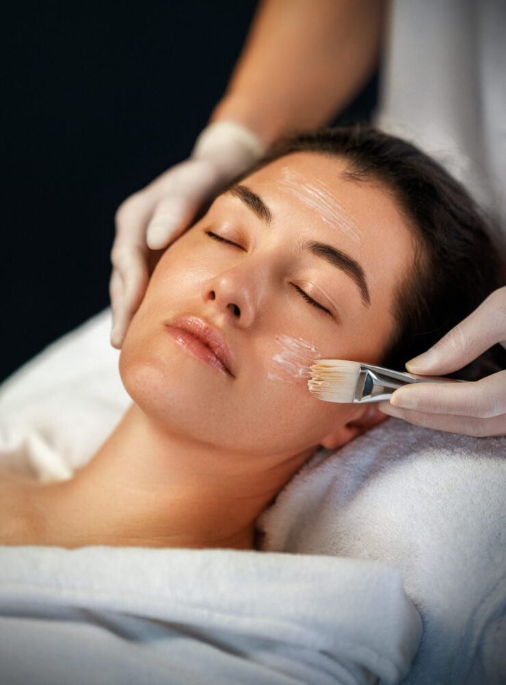 Facial treatment in spa salon. Skin care and massage. Cosmetologist at work